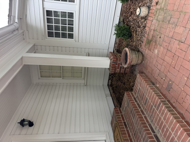 After: side entry of Pinehurst Village home cleared, brick steps and porch visible