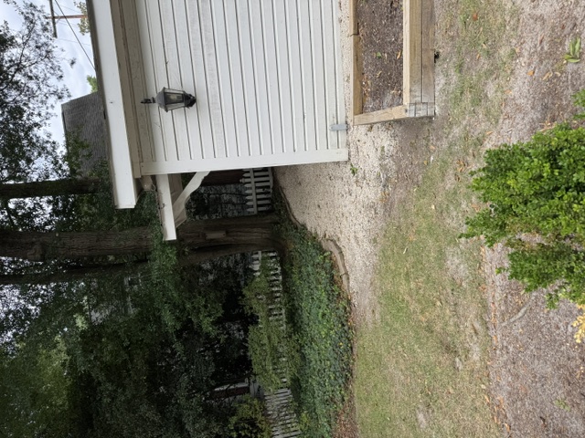 After: backyard and shed area of Pinehurst Village renovation home fully cleared